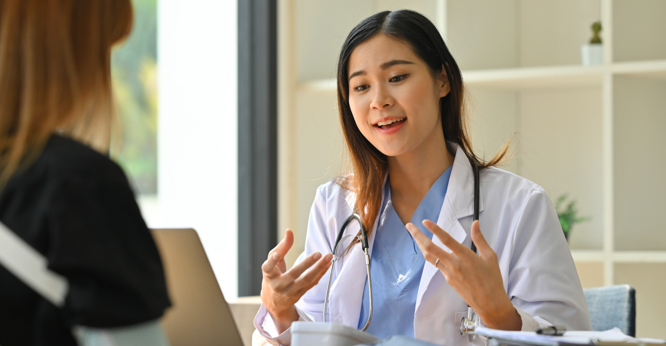 woman speaking with her primary care provider
