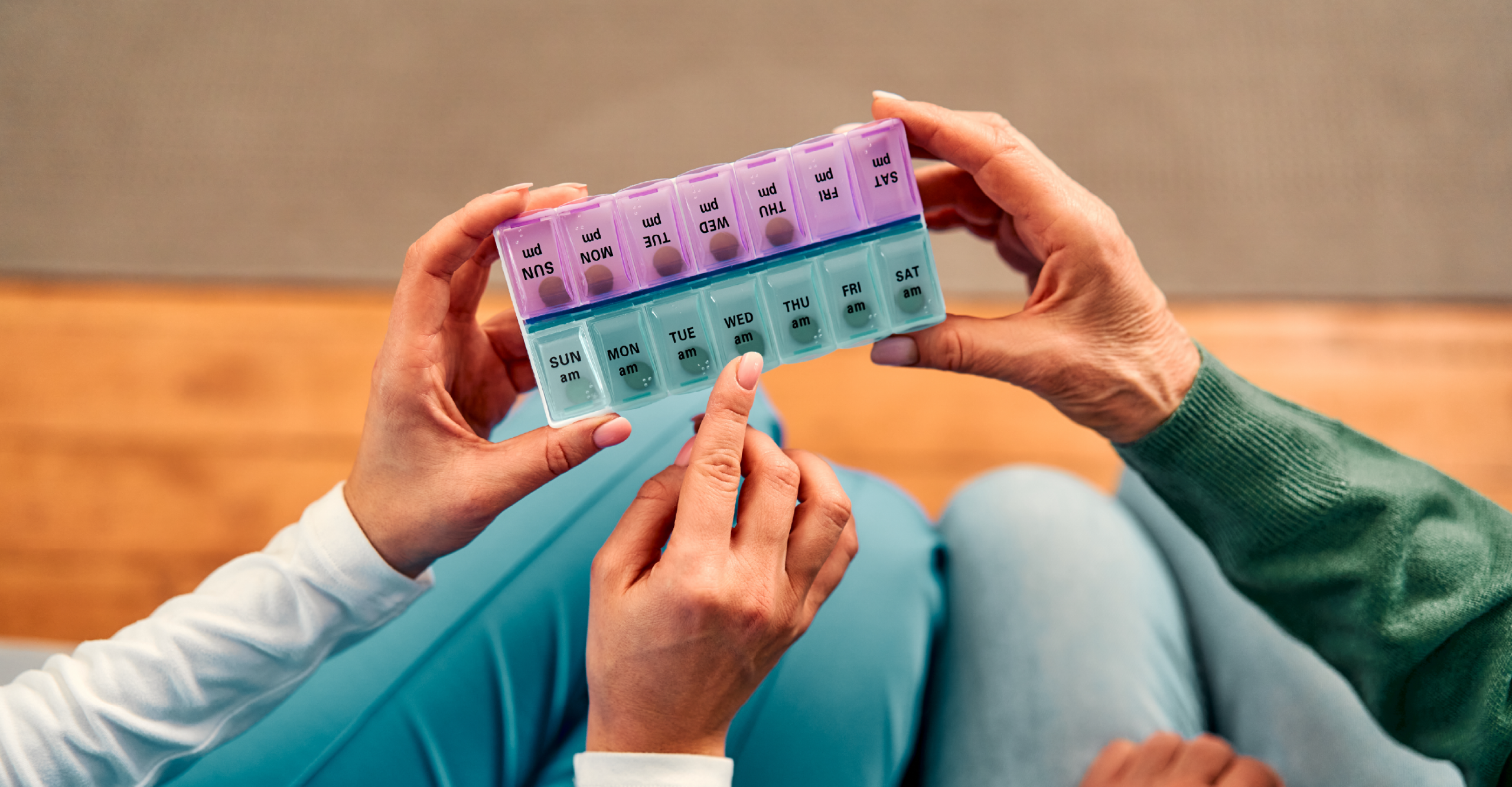 woman holding a vitamin organizer 