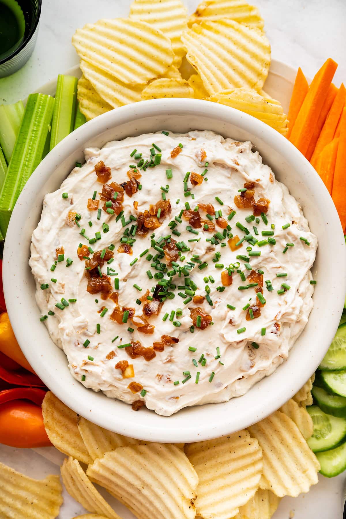 French onion dip served with chips, carrots, cucumbers, celery and peppers.